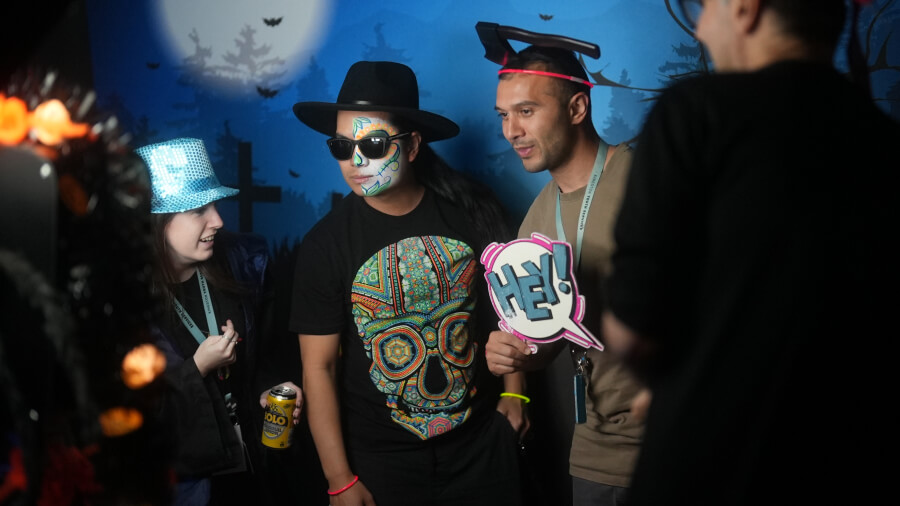 Youth Team posing in costumes at the photo booth.