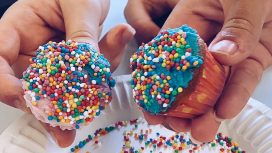 Blue iced cupcakes baked during Cook Bake Create. These cupcakes are covered in multi-coloured sprinkles.